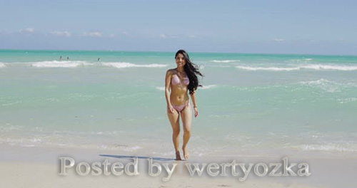 Delight Girl in Bikini Walking on Beach